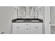 Bathroom featuring a double vanity with black countertops, modern lighting, and neutral paint at 617 Ray St, Selma, NC 27576
