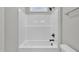 Bathroom featuring a shower-tub combo with white tile surround and black hardware at 617 Ray St, Selma, NC 27576