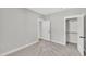 Neutral bedroom with plush carpet, white trim, and doors to a closet and ensuite bathroom at 617 Ray St, Selma, NC 27576