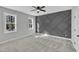 A bedroom boasting neutral paint, plush carpet, geometric accent wall and two windows at 617 Ray St, Selma, NC 27576