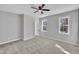 Bright bedroom with plush carpet, two windows that allow natural light, and neutral paint at 617 Ray St, Selma, NC 27576
