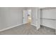 Bedroom with carpet, closet with shelves, and view to a sunlit room through an open door at 617 Ray St, Selma, NC 27576