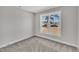 Bright bedroom features soft carpet, neutral paint, and a large window overlooking the neighborhood at 617 Ray St, Selma, NC 27576