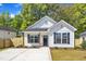 Charming new construction home with white siding, black shutters, and well-manicured lawn at 617 Ray St, Selma, NC 27576