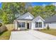 Charming new construction home with white siding, black shutters, and well-manicured lawn at 617 Ray St, Selma, NC 27576
