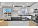 Bright kitchen with granite countertops, white cabinetry, and an island featuring pendant lighting at 617 Ray St, Selma, NC 27576
