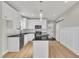 New kitchen with white cabinets, a kitchen island, modern appliances, granite countertops and natural light at 617 Ray St, Selma, NC 27576