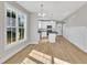 Open kitchen with white cabinets, a kitchen island, modern appliances and natural light at 617 Ray St, Selma, NC 27576