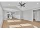Open-concept living room flowing into modern kitchen with a vaulted ceiling and bright light at 617 Ray St, Selma, NC 27576