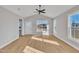Bright living room featuring vaulted ceiling, ceiling fan and multiple new windows that let in tons of natural light at 617 Ray St, Selma, NC 27576