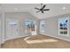Bright living room featuring vaulted ceiling, ceiling fan and plenty of new windows that let in lots of natural light at 617 Ray St, Selma, NC 27576