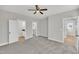 Spacious main bedroom featuring plush carpet, ceiling fan, and ensuite bathroom and walk-in closet at 617 Ray St, Selma, NC 27576