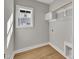 Bright walk-in closet with wood floors, storage shelves and hanging racks at 617 Ray St, Selma, NC 27576
