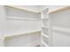 Spacious walk-in closet featuring a built-in shelving system and wooden clothes bars at 617 Ray St, Selma, NC 27576