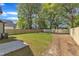Fenced backyard with lush green grass and a small concrete patio at 619 Ray St, Selma, NC 27576