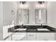 Double sink vanity with dark fixtures and large mirrors at 619 Ray St, Selma, NC 27576