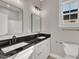 Bathroom featuring dual sinks, granite counters, and modern fixtures at 619 Ray St, Selma, NC 27576