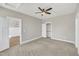 Neutral bedroom with ceiling fan, plush carpet, and walk-in closet at 619 Ray St, Selma, NC 27576