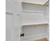 Walk-in closet with plenty of storage shelves and hanging rods at 619 Ray St, Selma, NC 27576