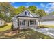 Charming single-story home with a welcoming front porch and black shutters and door at 619 Ray St, Selma, NC 27576