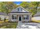 Charming single-story home with a welcoming front porch and black shutters and door at 619 Ray St, Selma, NC 27576