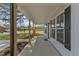 Wide view of the front porch with wooden support columns, a black front door, and black shutters at 619 Ray St, Selma, NC 27576