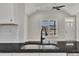 Kitchen with dark countertops, stainless steel sink, and view into the home's living area at 619 Ray St, Selma, NC 27576