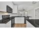 Modern kitchen showcasing granite countertops, stainless steel appliances, and white cabinetry at 619 Ray St, Selma, NC 27576