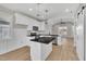 Open kitchen featuring white cabinets, black countertops, and stainless steel appliances at 619 Ray St, Selma, NC 27576