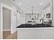 Modern kitchen with granite countertops, white cabinets, and stainless steel appliances at 619 Ray St, Selma, NC 27576