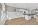 Open concept kitchen with white cabinetry, black countertops, and stainless appliances at 619 Ray St, Selma, NC 27576