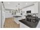 Bright kitchen featuring white cabinets, black granite countertops, and a kitchen island at 619 Ray St, Selma, NC 27576