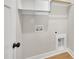 Bright laundry area featuring a shelf, rod, and hookups, ensuring a functional space at 619 Ray St, Selma, NC 27576