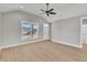 Bright living room featuring vaulted ceilings, luxury vinyl plank flooring, and a modern ceiling fan at 619 Ray St, Selma, NC 27576