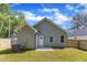 Rear exterior view of the house, showcasing the backyard and its landscaping at 621 Ray St, Selma, NC 27576