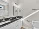 Bathroom featuring double sinks with black granite countertops at 621 Ray St, Selma, NC 27576