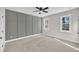 Spacious bedroom features neutral carpet, accent wall, and windows providing natural light at 621 Ray St, Selma, NC 27576