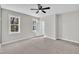 Bright bedroom with neutral carpet, ceiling fan, and a door leading to another room at 621 Ray St, Selma, NC 27576
