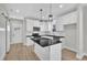 Modern kitchen with white cabinets, stainless steel appliances, and an island with pendant lighting at 621 Ray St, Selma, NC 27576