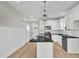Modern kitchen with a center island, white cabinets, granite countertops, and stainless steel appliances at 621 Ray St, Selma, NC 27576