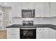Kitchen features stainless steel appliances, white cabinets and subway tile backsplash at 621 Ray St, Selma, NC 27576