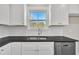 Kitchen features stainless steel sink, white cabinets, black countertops, subway tile backsplash and stainless steel appliances at 621 Ray St, Selma, NC 27576