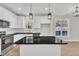 Well-lit kitchen with granite countertops, an island with a sink, and stainless steel appliances at 621 Ray St, Selma, NC 27576