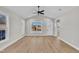 Bright living room with a vaulted ceiling, ceiling fan, sleek floors, and natural light at 621 Ray St, Selma, NC 27576