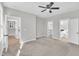 Spacious carpeted bedroom featuring a ceiling fan, walk-in closet, and en suite bathroom at 621 Ray St, Selma, NC 27576