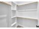 Bright walk-in closet with wooden rods and shelves at 621 Ray St, Selma, NC 27576