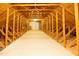 Unfinished attic space with wooden beams and a small door at 627 Carraway Dr, Graham, NC 27253