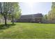 Large backyard with lawn and brick home in the background at 627 Carraway Dr, Graham, NC 27253