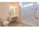 Bright bathroom with white shower, tile flooring, sink, and toilet at 627 Carraway Dr, Graham, NC 27253
