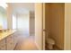 Bathroom with sink, toilet and shower with light yellow walls at 627 Carraway Dr, Graham, NC 27253